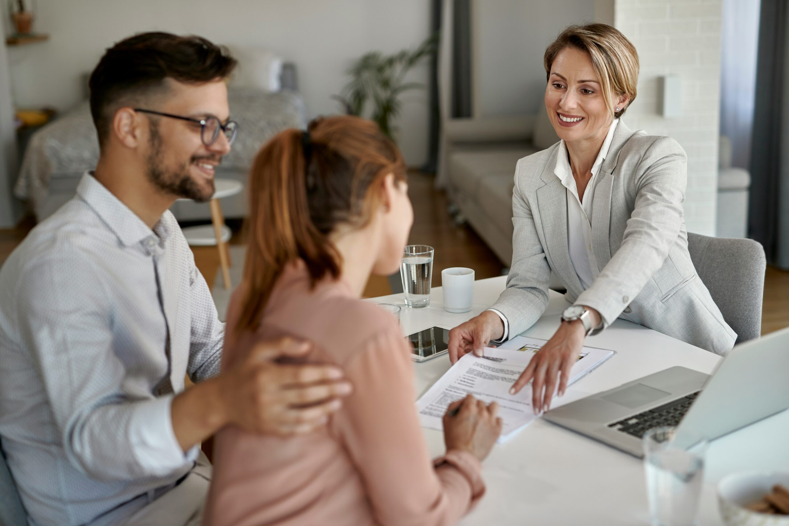 Couple meeting with a notary to sign their home purchase documents