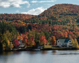 Chalet à vendre dans les Laurentides, au bord d'un lac entouré de forêt en fin d'après-midi