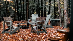 Adirondack chairs around a fire pit on autumn leaves at a Laurentians cottage
