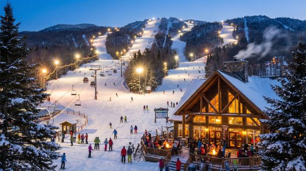 Skiers on a brightly lit slope, a key part of Saint-Sauveur winter activities and one of the top things to do in Saint-Sauveur